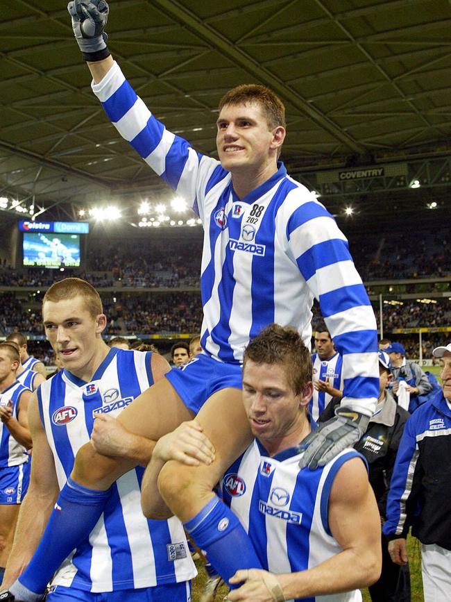 Bali bombing survivor Jason McCartney was chaired from ground after making his AFL comeback in Round 11, 2003. Pic: Michael Klein