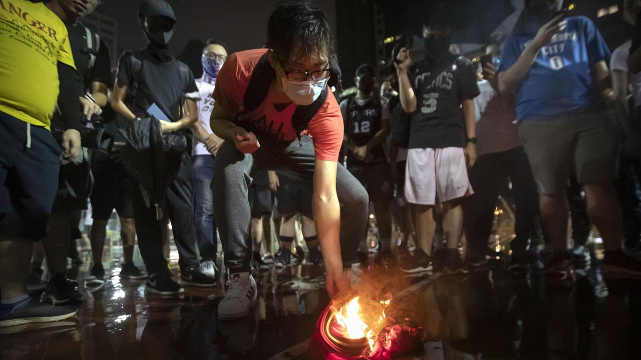 Demonstrators set a LeBron James jersey on fire during a rally in Hong Kong.