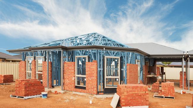 New residential construction home from brick with metal framing against a blue sky; real estate Australian generic suburban homes
