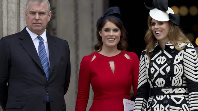 Prince Andrew and his daughters, Princess Eugenie of York Princess Beatrice of York. Picture: JUSTIN TALLIS / AFP