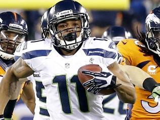 Seattle Seahawks' Percy Harvin (11) runs from Denver Broncos' David Bruton (30) while returning a kickoff 87-yards for a touc...