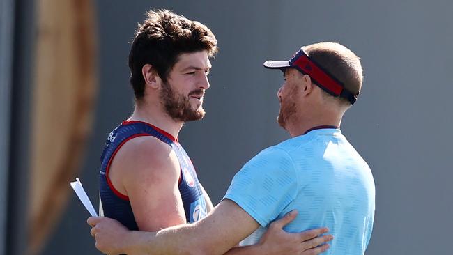 MELBOURNE, AUSTRALIA - September 11 , 2023. AFL.    Angus Brayshaw shakes hands with and hugs coach Simon Goodwin during Melbournes training session at Casey Fields, Cranbourne   Photo by Michael Klein.