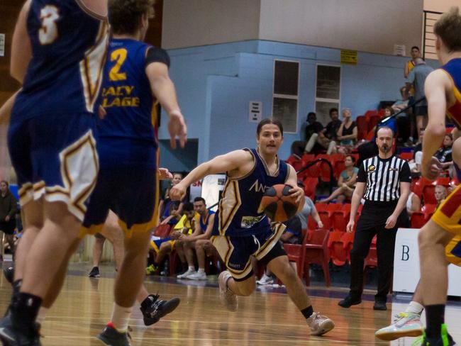 Anthony Rowse drives to the back for Ansett against Tracy Village. Picture: Jasmine Harrison