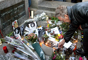 Light my fire ... The Door's former keyboard player, Ray Manzarek, lights a candle Jim Morrison's grave at Pere Lachaise cemetery, Paris, in 2003 for the 60th birthday of the band's late singer. Picture: Reuters