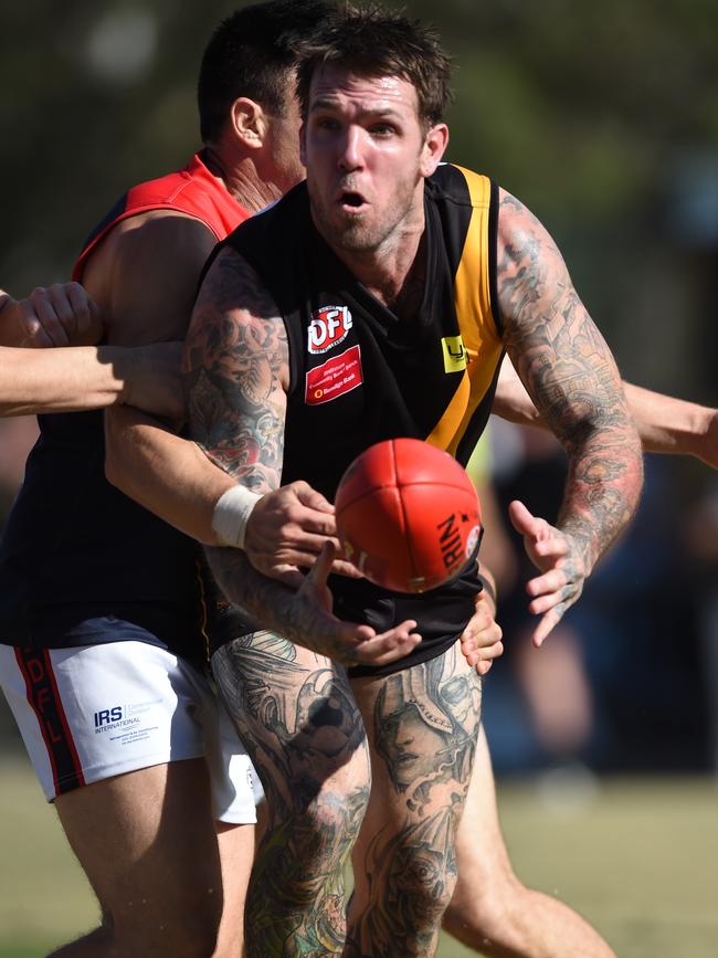 Dane Swan is put under pressure. Picture: Lawrence Pinder