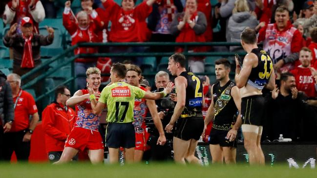 Richmond players appeal to AFL field umpire John Howorth for a controversial 50m penalty after the siren which was not awarded. Picture: Dylan Burns/AFL Photos via Getty Images