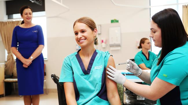 Premier Annastacia Palaszczuk watches as Gold Coast Health staffer Zoe Park gets the Covid vaccination in March. Picture: Nigel Hallett.