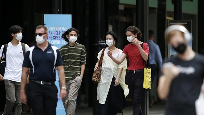 People pictured wearing masks in the Brisbane CBD\1. This Friday people in Greater Brisbane won't have to wear masks. Picture: Image/Josh Woning