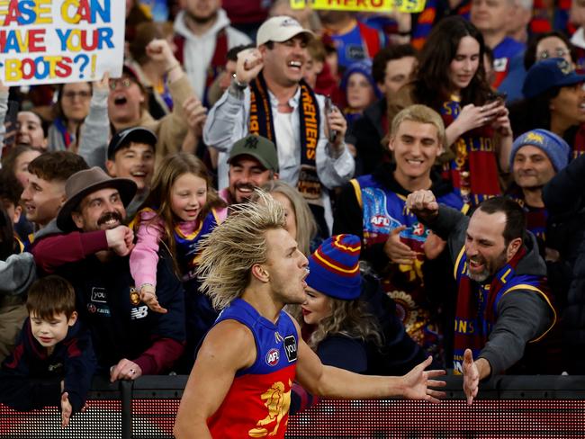 MELBOURNE, AUSTRALIA - SEPTEMBER 21: Kai Lohmann of the Lions celebrates with fans during the 2024 AFL Second Preliminary Final match between the Geelong Cats and the Brisbane Lions at The Melbourne Cricket Ground on September 21, 2024 in Melbourne, Australia. (Photo by Michael Willson/AFL Photos via Getty Images)