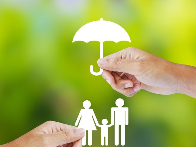 Hand holding a paper family and umbrella on green background concept income protection insurance generic, life insurance, family