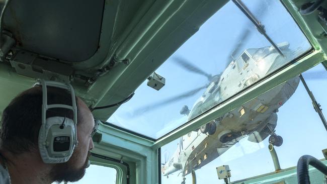 Royal Australian Navy Lieutenant Edward Costigan watches as an Indian Navy Sea King helicopter prepares to land on frigate HMAS Parramatta’s flight deck during AUSINDEX 2019. Picture: ADF