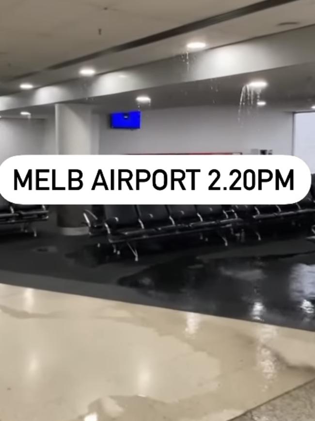 Water pours through the roof of a departure lounge at Melbourne Airport on Thursday. Picture: Jacqui Felgate