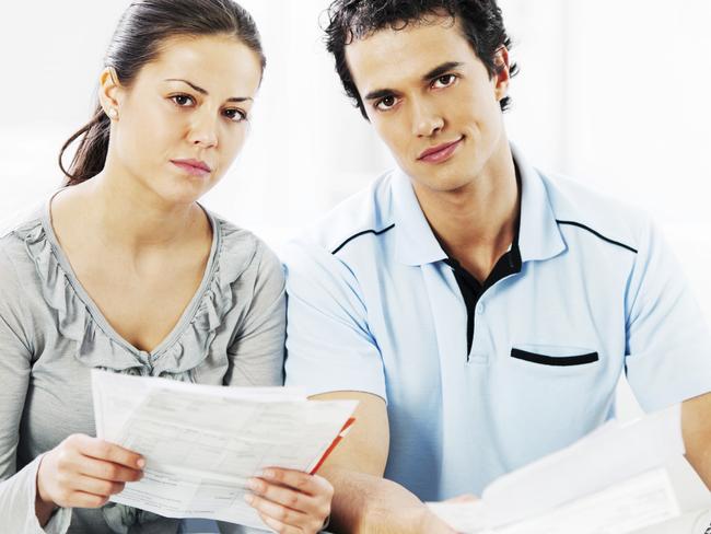 A stressed couple are working out how to manage their household bills in their home loan. Picture: iStock.