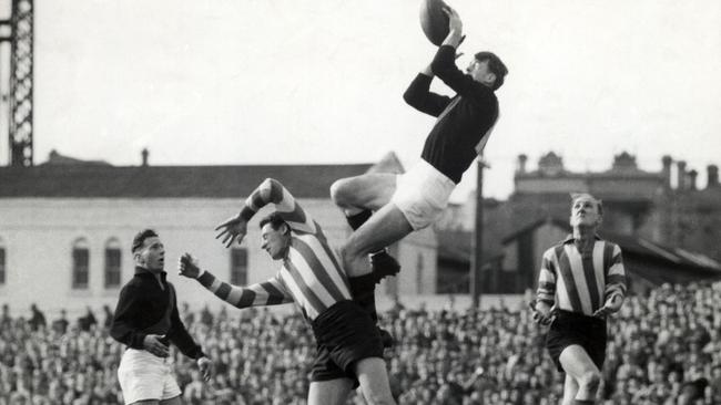 John Coleman marks over Vic Lawrence in 1953.
