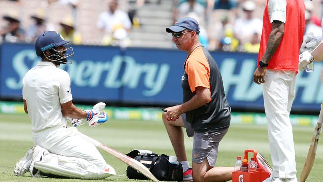 Virat Kohli receives treatment from team physio Pat Farhart. Picture: Michael Klein