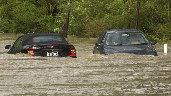 Two cars trapped by floodwaters on Wakehurst Parkway in October 2003. Proposed flood mitigation work could help this occuring as often. Picture: John Grainger