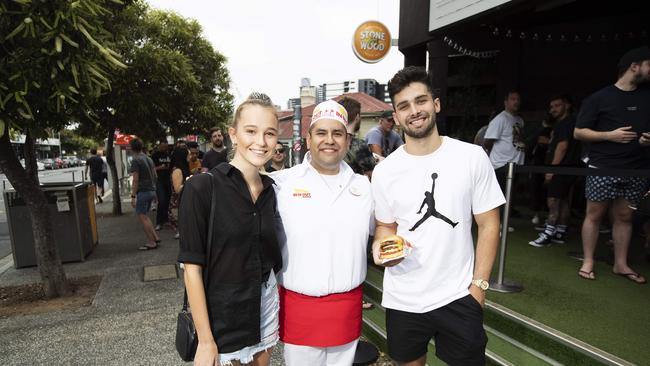 Bailee OÕNeil, 20, and Xavier McKinley, 21, and In-N-Out chef Luis Hernandez at the In-N-Out burger pop-up store at Archive Beer Boutique. Photo: Attila Csaszar