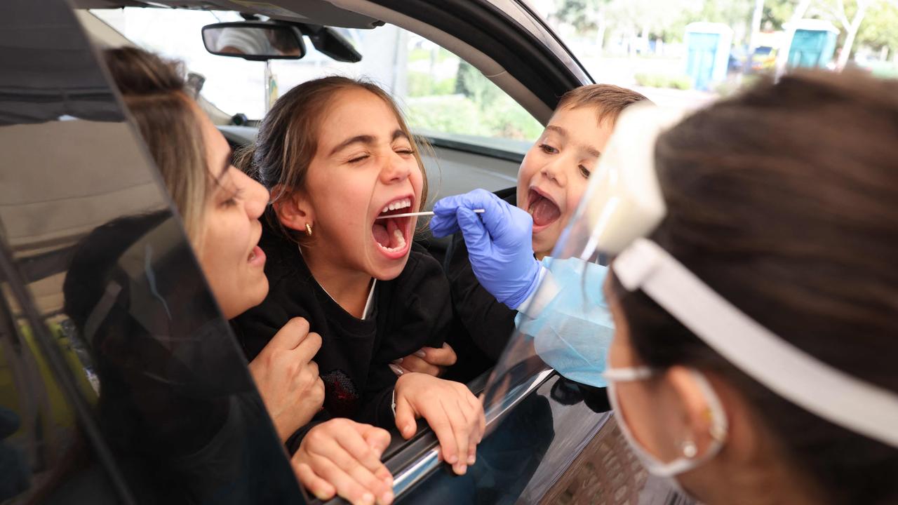 An Israeli paramedic collects a swab sample from a child at the Magen David Adom (Red Shield of David) Covid-19 testing centre in Jerusalem on January 11, 2022. Picture: Menahem Kahana/AFP