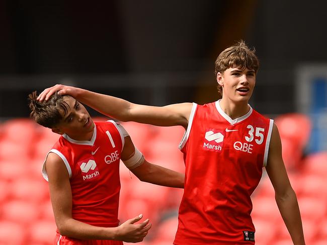 James O'Loughlin with Aidan McCartney. Picture: Albert Perez/AFL Photos via Getty Images