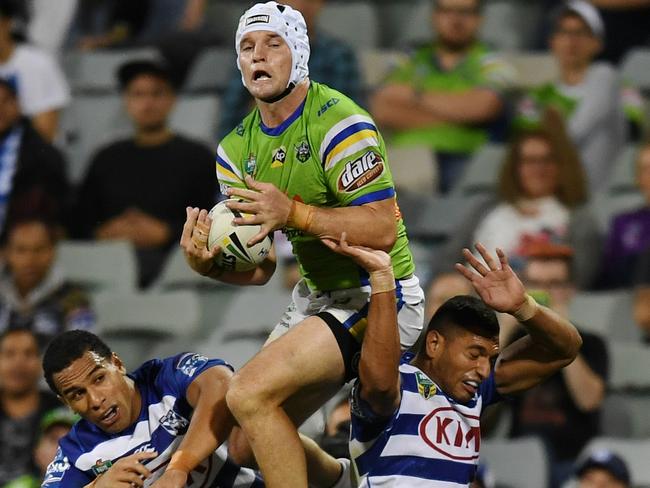 Jarrod Croker leaps above the Bulldogs defence to take a catch and score a try.