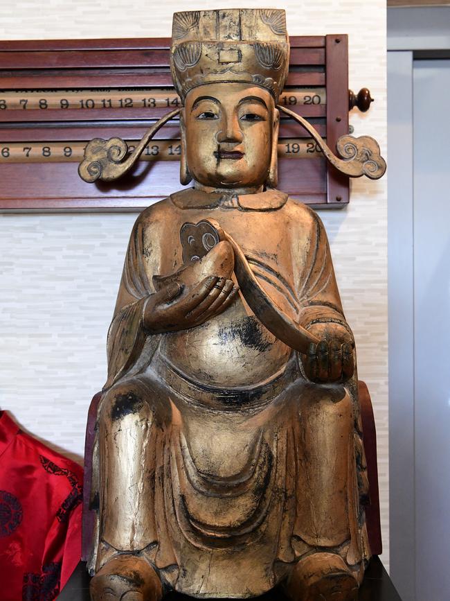 A Chinese Giltwood figure of Caishen (God of Wealth), which was given to former prime minister Bob Hawke by businessman and politician of Malaysia Sir Thomas Teng in 2006 is photographed at his home in Northbridge, Sydney, Wednesday, August 21, 2019. A range of items belonging to Bob Hawke and Blanche D'Alpuget will go to auction on August 27. (Bianca De Marchi)