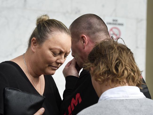 The McGuires comfort each other outside court. Picture: Andrew Henshaw