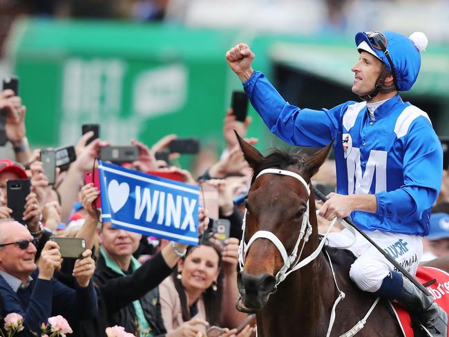 Jockey Hugh Bowman riding Winx celebrates after wining a fourth Cox Plate on Winx.