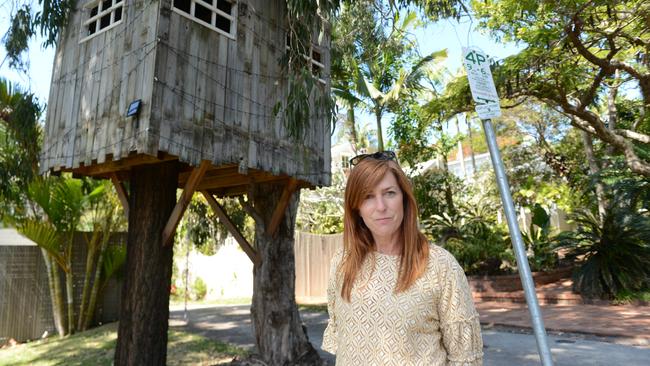 Byron Bay mother Mellanie Coppin with the treehouse outside her home. A lease for the use of the road reserve area will go back before Byron Shire Council soon.