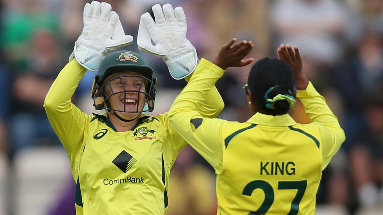 Alyssa Healy and Alana King celebrate after taking the wicket of England star Tammy Beaumont. Picture: Steve Bardens/Getty Images