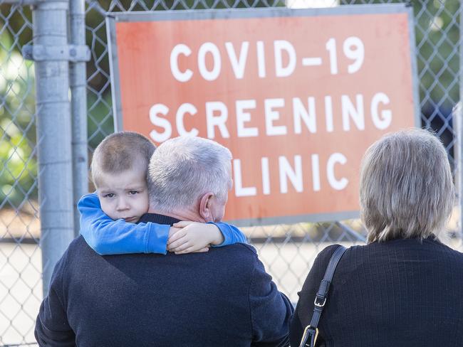 BRISBANE, AUSTRALIA - NewsWire Photos JULY 29, 2020: A boy waits with his family to get COVID tested at the Parklands Christian College in Park Ridge. Picture: NCA NewsWire / Jono Searle