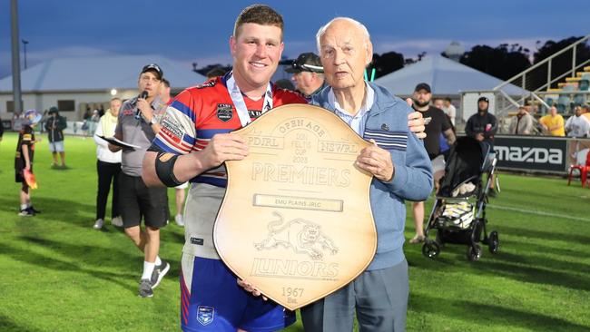 Emu Plains captain Thomas Romer holds the Don Feltis Shield alongside Don Feltis after Emu Plains defeated Windsor 32-26 in the Open Men’s Division 1 grand final at St Marys Leagues Stadium. Picture: Steve Montgomery