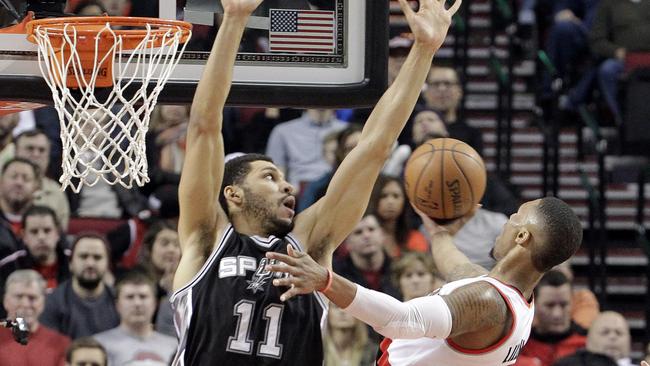 Portland Trail Blazers guard Damian Lillard, right, goes to the hoop.