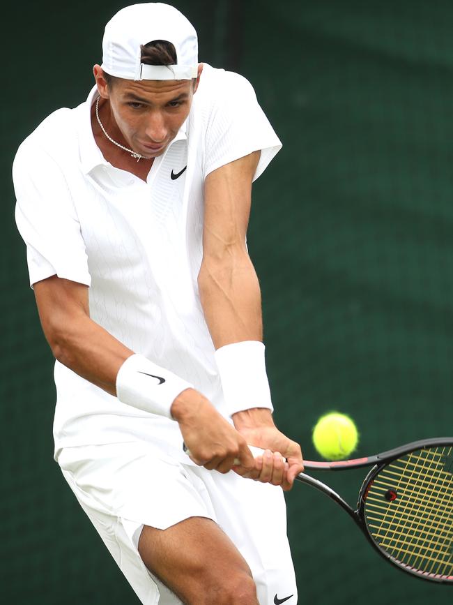 Alexei Popyrin hits a backhand during his Wimbledon qualifying victory over Mats Moraing. Picture: Getty Images