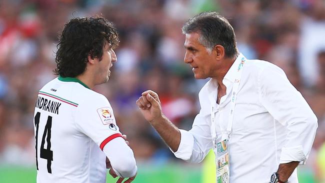 Iran coach Carlos Queiroz talks with Andranik Teymourian.