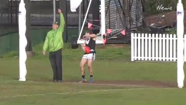 Goal umpire whacks footballer with flag