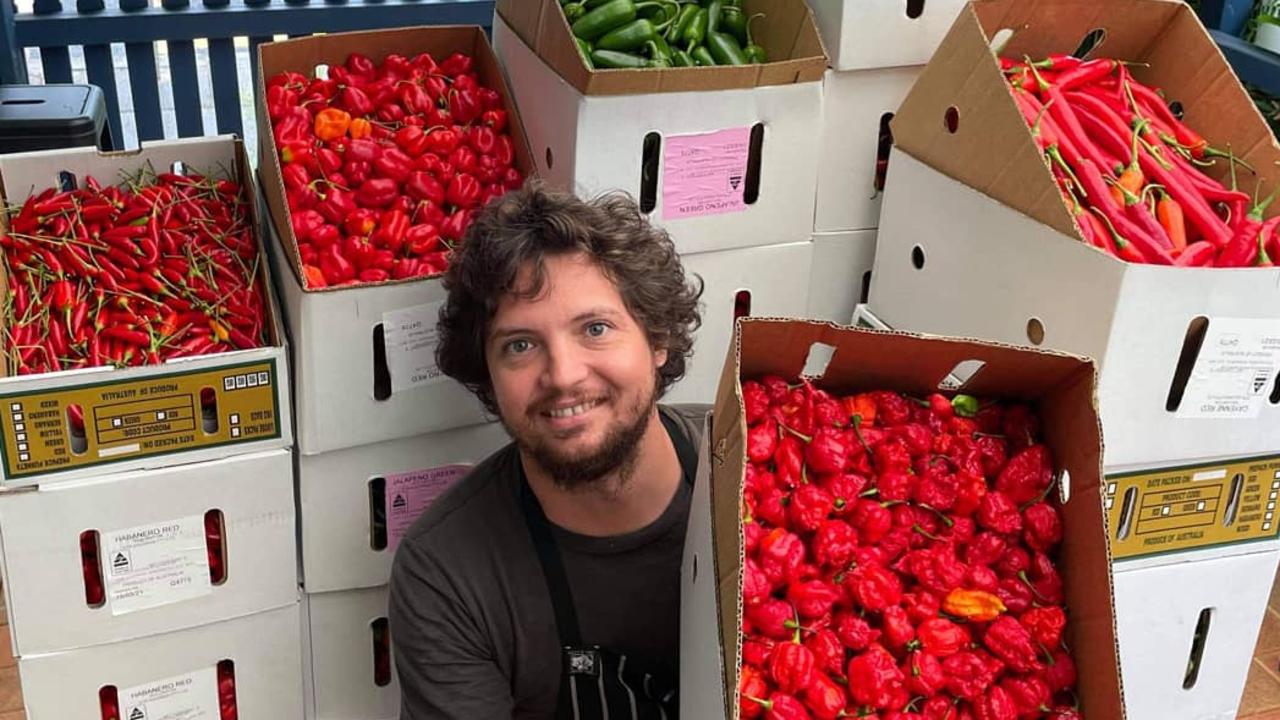 Village Pickle chilli Co co-founder Brendan Chan with the many varieties of chilli he uses to make fermented hot sauce. Picture: Supplied