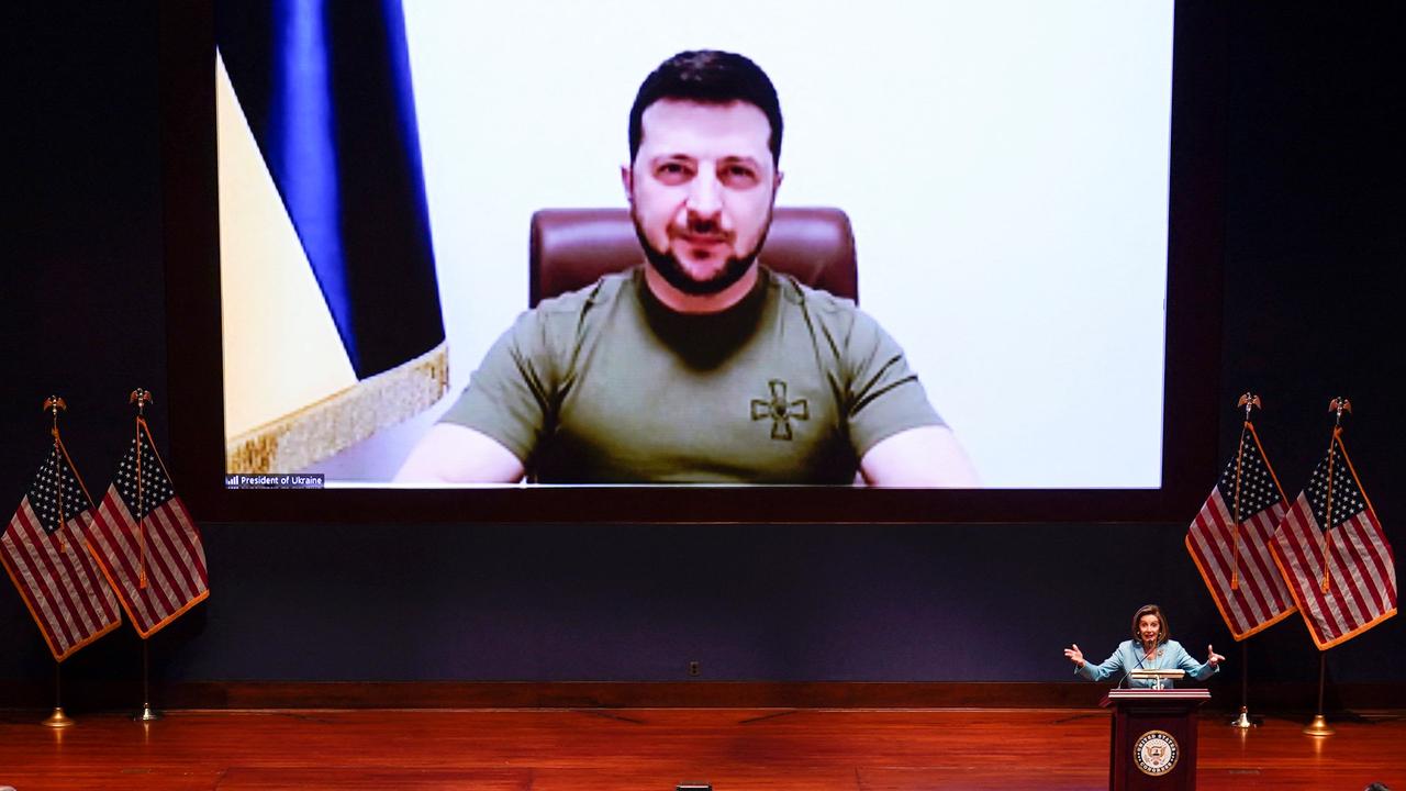 US Speaker of the House Nancy Pelosi (at podium) introduces Ukrainian President Volodymyr Zelensky (on screen) before his virtual address to the US Congress. Picture: J. Scott Applewhite / POOL / AFP