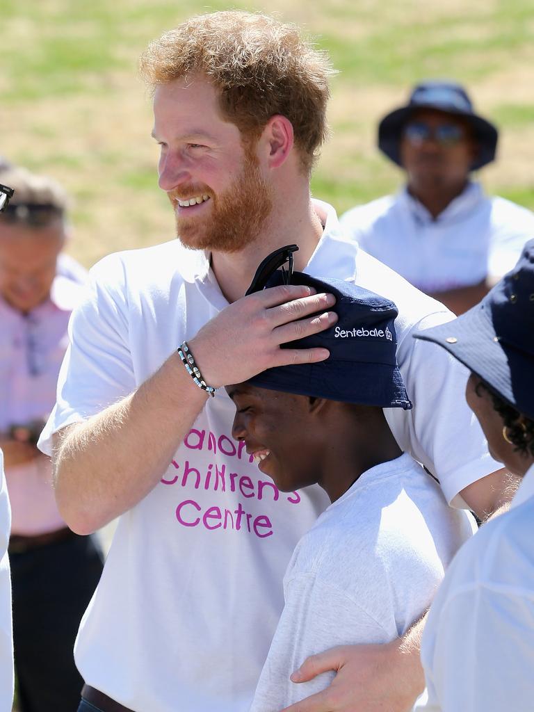 Prince Harry hugs ‘Mutsu’ a young boy he made friends with on his first visit to Lesotho at the Official Opening of the new Mamohato Children’s Centre on November 26, 2015 in Maseru, Lesotho. Picture: Getty