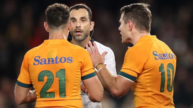 Referee Mathieu Raynal speaks to Nic White and Bernard Foley after the controversial call. Picture: Getty Images