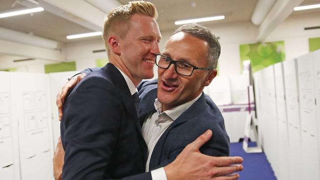 Greens candidate for Higgins Jason Ball and party leader Richard Di Natale embrace after voting in Toorak. Picture: Getty Images