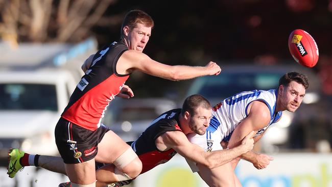 Corowa-Rutherglen’s Jordan Foote is outnumbered by Myrtleford pair Jake Sharp and Matt Munro.