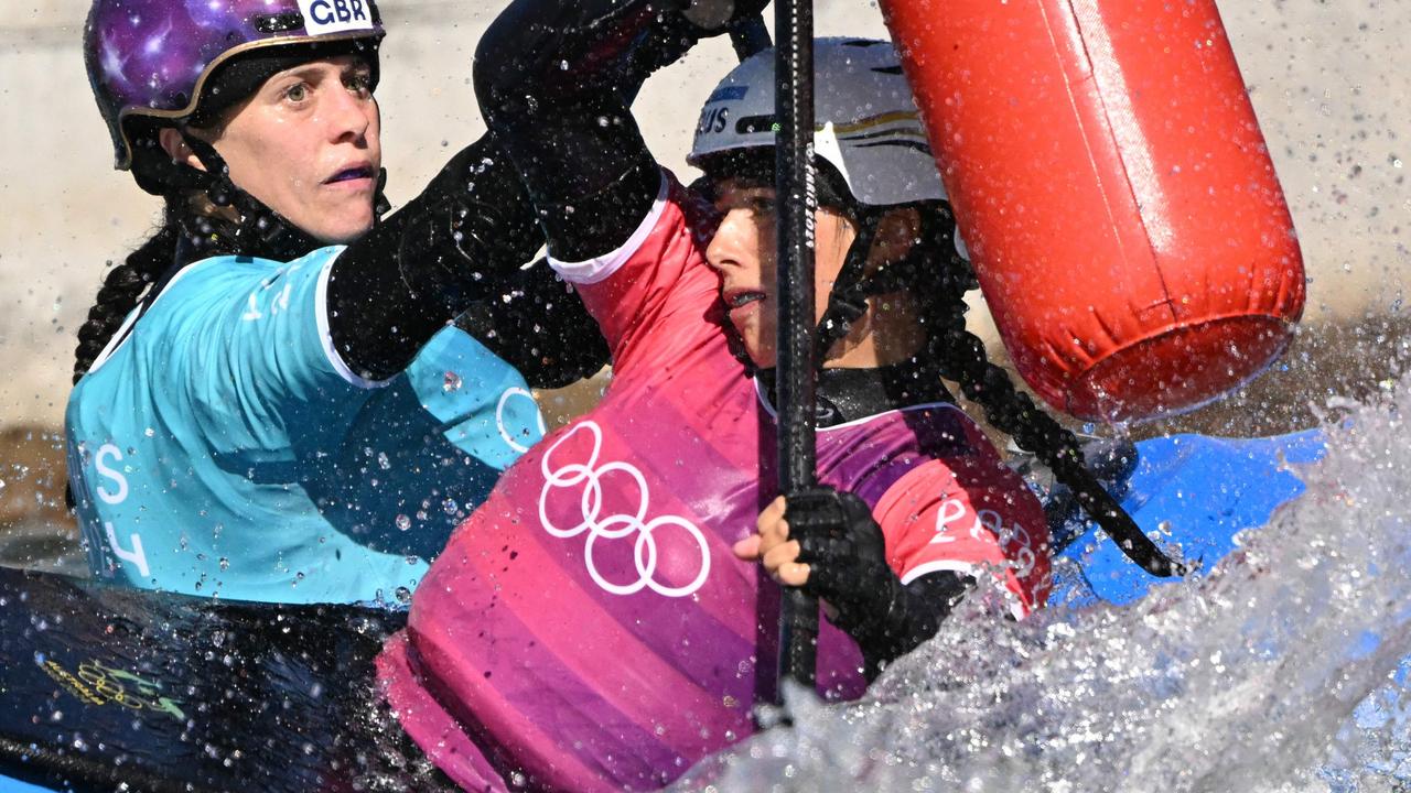 Australia's Noemie Fox, right, competes against Britain's Kimberley Woods in the women's kayak cross final of the canoe slalom competition at Vaires-sur-Marne Nautical Stadium in Vaires-sur-Marne on August 5. Picture: Bertrand Guay/AFP