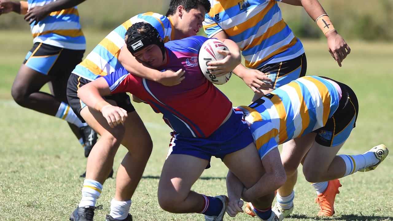 Boys Rugby League State Championship held at Northern Division, Brothers Leagues ground, Townsville. 16-18 years. Peninsula (stripe) v Darling Downs (blue/purple). Thomas Fenwick of Toowoomba Grammar School.