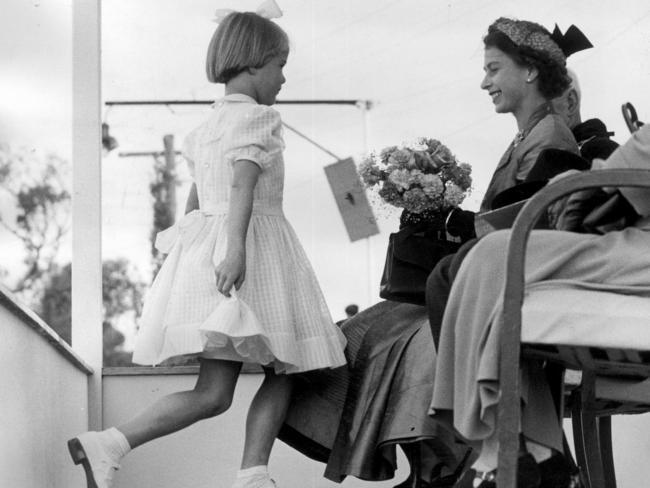 Ruth Trigg presents flowers to Queen Elizabeth II.