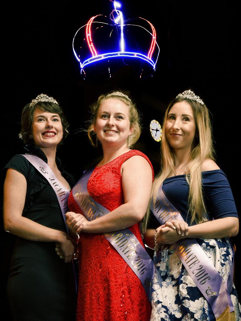 2016 Jacaranda candidates Sharni Wren, Heidi Madsen and Shannon Carter in front of the lit up Jacaranda Crown that was placed on top of the clock tower in preparation for the festival.