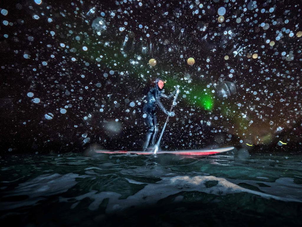 Myrtille Heissat from France rides a SUP (Stand Upp Paddle) under Northern Lights, on March 8, 2018 in Unstad northern Norway, Lofoten islands, within the Arctic Circle. Picture: AFP