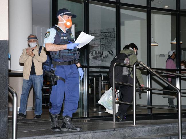 Quarantined travellers are moved out of the Travelodge Hotel. Picture: Bill Hearne