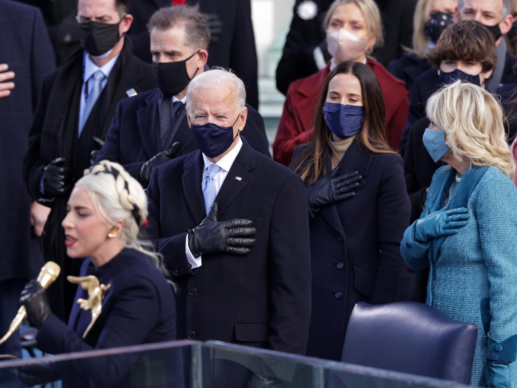 Lady Gaga sings the US anthem, as President-elect Joe Biden and First Lady Jill Biden stand. Picture: Getty Images