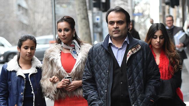 Pankaj and Radhika Oswal with their daughters Riddhi, 12, and Vasundhara, 18, leave the Supreme Court of Victoria in Melbourne on Tuesday.