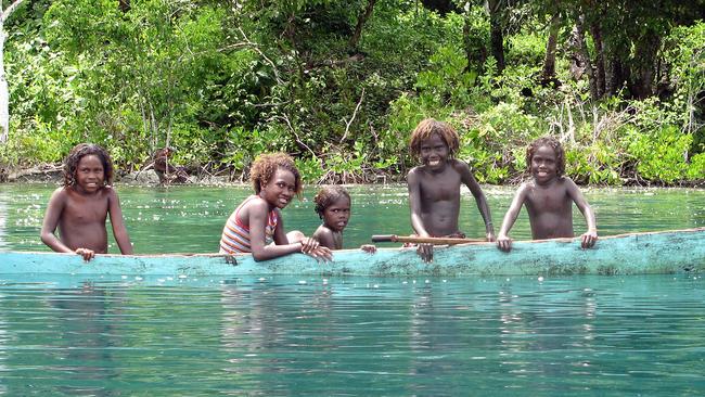 Solomon Islands, children in a canoe somewhere off Gizo.